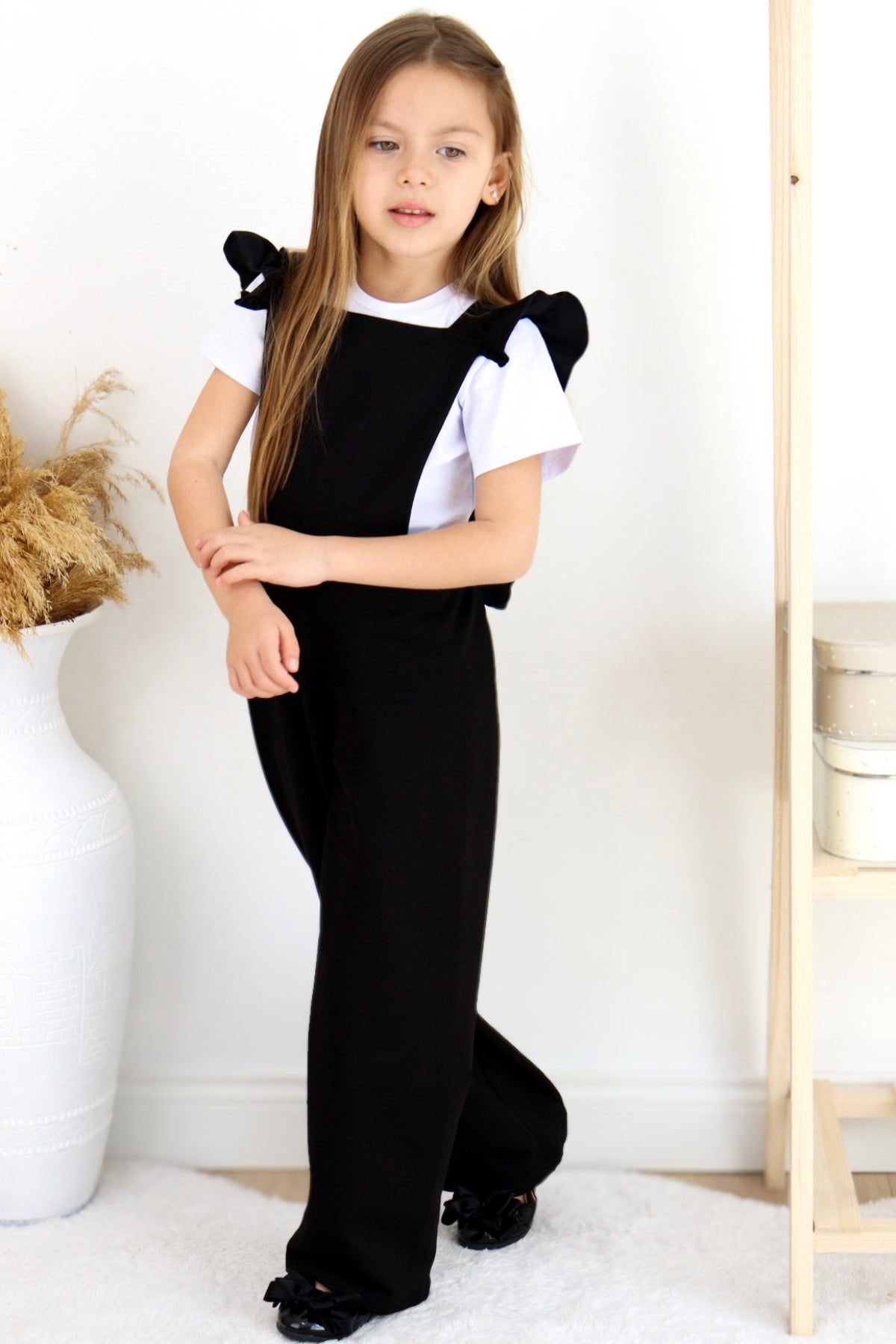 Schwarze Salopette Berlin - Jumpsuit in Schwarz mit Volantschultern und Haarspange